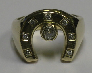 A gold ring in the form of a horse shoe set 8 diamonds