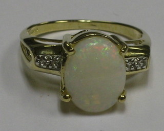 A 9ct gold dress ring set an opal coloured stone