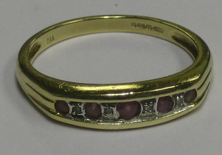 A lady's 9ct gold dress ring set 5 pink sapphires interspaced by 4 diamonds
