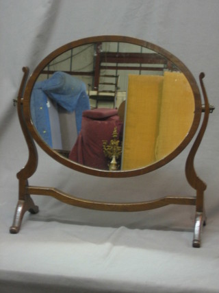 A Georgian style oval plate dressing table mirror contained in a mahogany swing frame