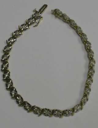 A lady's 9ct gold bracelet set 30 various diamonds