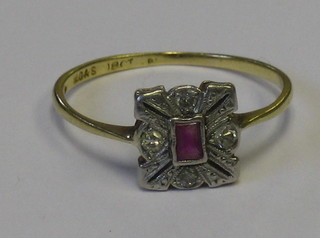 An 18ct gold dress ring set a rectangular cut ruby supported by an illusion set diamond