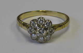 A lady's 18ct gold cluster dress ring set 9 diamonds
