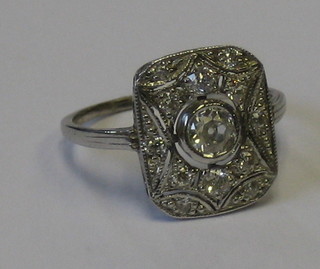 A lady's 18ct pierced white gold dress ring set a large cut circular diamond supported by numerous other diamonds