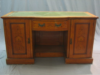 An Edwardian inlaid satinwood writing table/dressing table with inset tooled green leather writing surface, the base fitted 1 long drawer flanked by a pair of cupboards 53"
