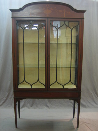 An Edwardian inlaid mahogany display cabinet, the interior fitted adjustable shelves enclosed by astragal glazed panelled doors 39"