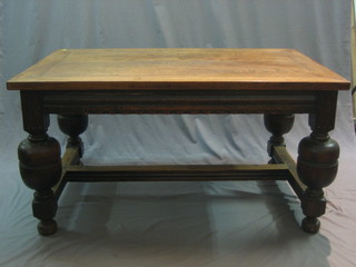 A 17th Century style oak refectory dining table raised on bulbous turned supports united by an H framed stretcher 55"