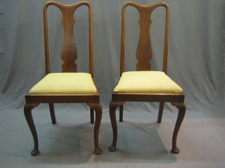 A pair of Queen Anne style mahogany splat back dining chairs with H framed stretchers, raised on cabriole supports