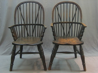 A set of 6 dark elm comb back carver chairs with solid seats, raised on turned supports