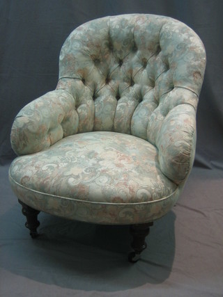 A Victorian mahogany framed tub back armchair upholstered in buttoned floral material