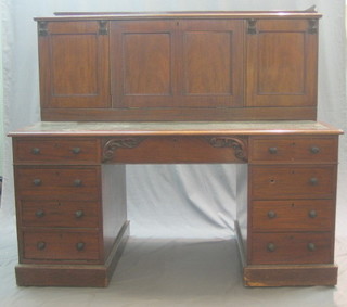 A Victorian mahogany desk having a super structure to the top fitted cupboards, the writing surface inset green leather above 1 long and 8 short drawers 60"