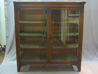 A Victorian oak display cabinet, the interior fitted adjustable shelves enclosed by glazed panelled doors 49"