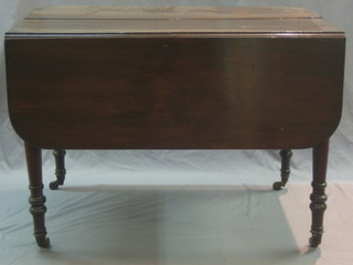 An unusual Victorian mahogany drop flap dining table, the centre section fitted 3 extra leaves, raised on turned supports