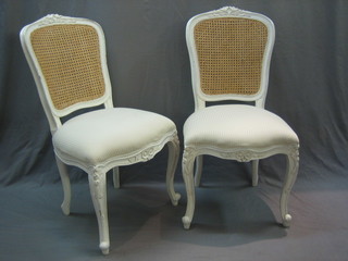 A pair of French style salon chairs with cane backs and upholstered seats, raised on cabriole supports