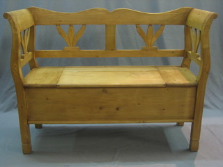 A Continental pine settle, the seat with hinged lid 47" 