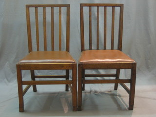 A set of 12 Georgian style Country oak stick and bar back dining chairs