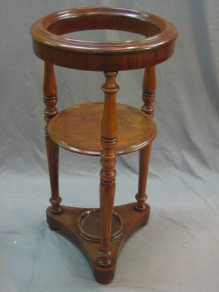 A circular William IV mahogany wash stand raised on a turned column with triform base 16"