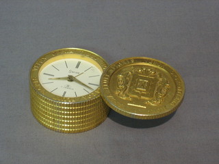 A Swiza 8 day travelling alarm clock contained in a gilt metal case