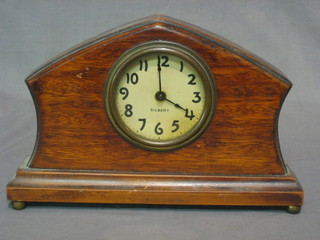 An Art Deco bedroom timepiece by Gilbert with paper dial and Arabic numerals contained in an oak shaped case