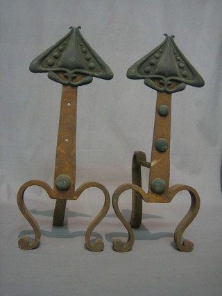 A pair of Art Nouveau wrought iron fire dogs