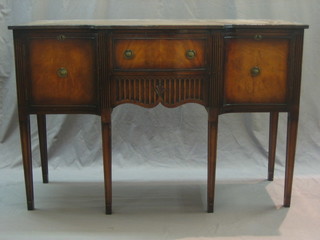 A Georgian style mahogany sideboard of serpentine outline with drawer flanked by double cupboards, raised on square tapering supports 54"