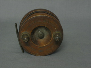 A wooden and brass steel backed fishing reel 3 1/2"