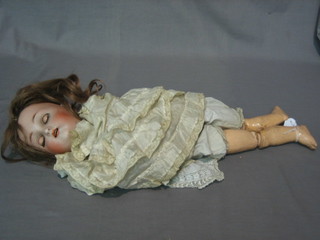 A 19th Century porcelain headed doll with open and shutting eyes, open mouth and articulated body 20"