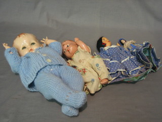 A Pedigree celluloid baby doll, 1 other baby doll, a double sided costume doll and a small plastic doll