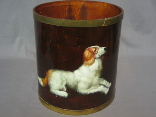 A waste paper basket painted a figure of a seated dog