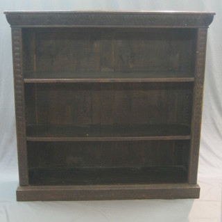 A Victorian carved oak bookcase fitted adjustable shelves 48"