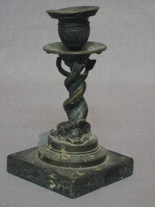 A 19th Century bronze candlestick supported by dolphins, raised on a marble base 7"