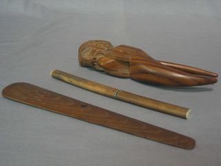 A pair of nut crackers in the form of a gentleman's head, a wooden paper knife marked Winchester Cathedral oak 1897 and a Japanese dagger