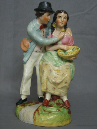 A 19th Century Staffordshire figure of a couple with bowl of buttercups 11"