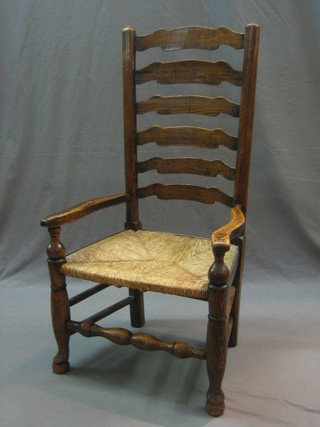 An 18th/19th Century elm ladder back carver chair with woven cane seat