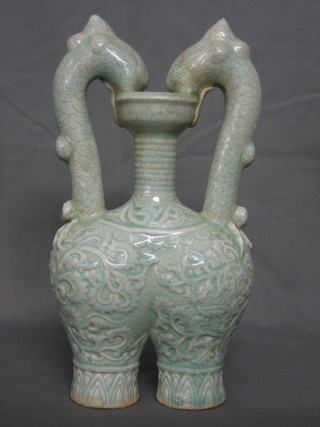 A handsome 17th/18th Century Oriental turquoise glazed double vase, the handle in the form of 2 dragon heads 12"