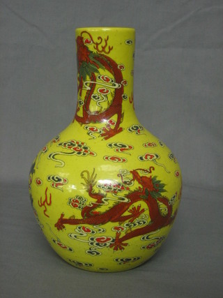 An 18th/19th Century Oriental yellow glazed club shaped vase with dragon decoration, the base with seal mark 8 1/2"
