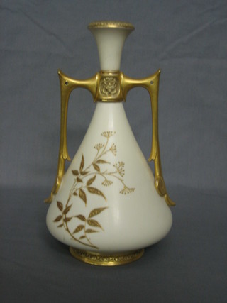 A Royal Worcester blush ivory ground twin handled vase, with gilt decoration, the base marked 1021, 10"