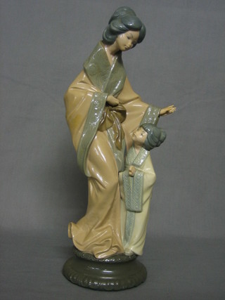 A Nao figure of a standing Oriental lady and child, the base marked Nao 15"