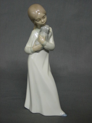 A Nao figure of a standing girl with puppy 8"