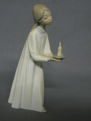 A Lladro figure of a standing girl with chamber stick, the base impressed 13, 7"