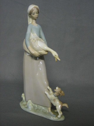 A Lladro figure of a standing lady with geese and puppy 10"