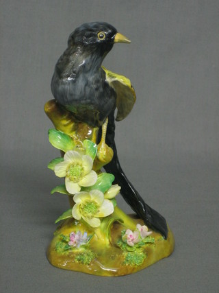A Royal Crown Staffordshire figure of a seated bird modelled by Jones, 6"