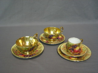 A pair of Aynsley cups and saucers with fruit decoration, a circular tea plate decorated fruit and a coffee can and saucer decorated fruit