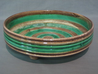 A Continental circular blue and brown glazed Art Pottery fruit bowl raised on 3 feet, 11"