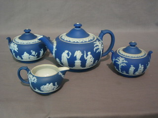 A Wedgwood blue Jasperware teapot, the base impressed Wedgwood 24, 2 do. sucriers and a cream jug
