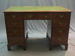 A walnut kneehole pedestal desk with green leather inset writing surface above 1 long and 8 short drawers, raised on bracket feet 45"