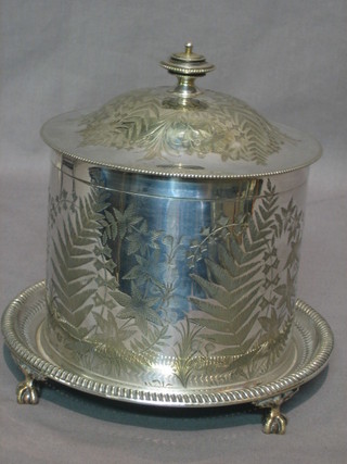 A circular engraved silver plated biscuit barrel with hinged lid