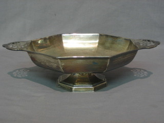 A silver octagonal twin handled fruit bowl raised on an octagonal spreading foot, Sheffield 1929, 20 ozs