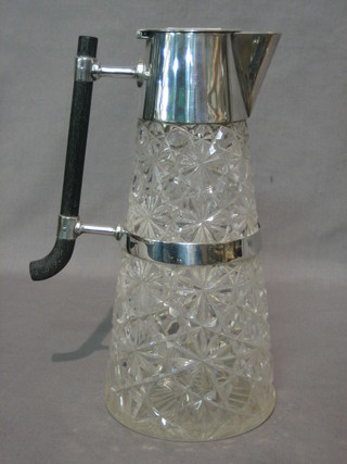 A Dresser style cut glass claret jug with silver plated mounts