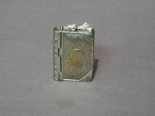 A silver plated vesta/match box in the form of a book
